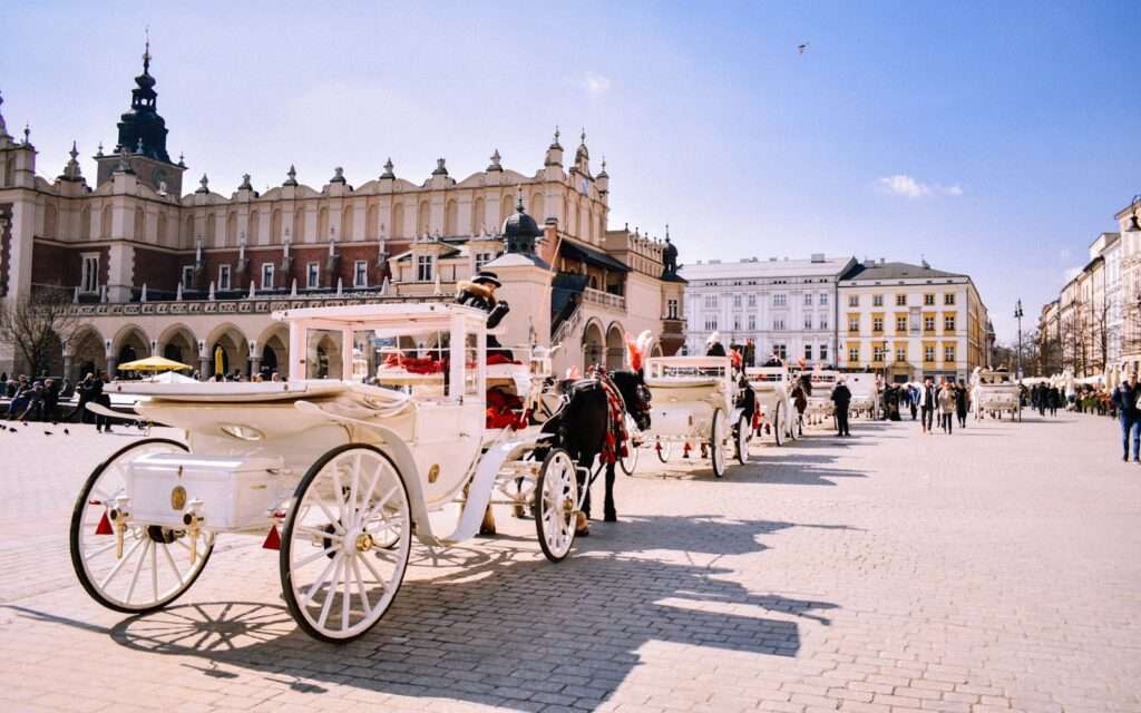 Horse-drawn carriages in front of the Cloth Hall on Krakow's Main Market Square